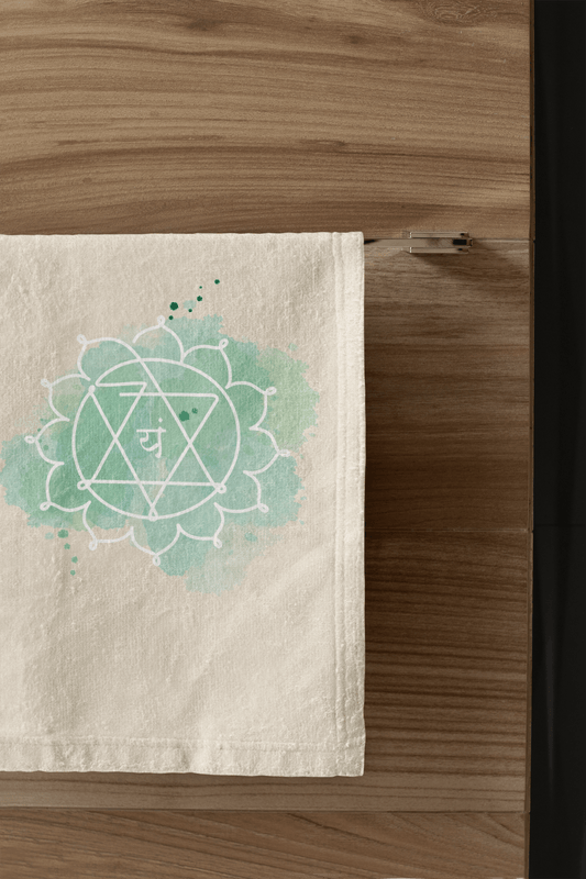 Heart Chakra hand towel showcasing the Anahata symbol, representing love and compassion, styled in a contemporary bathroom."