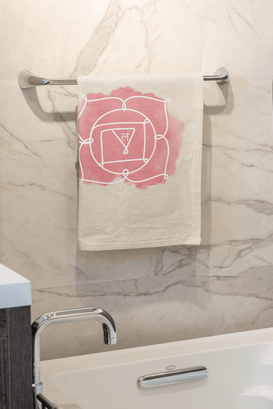 Root Chakra hand towel featuring Muladhara symbol for grounding and stability, hanging in a modern bathroom.