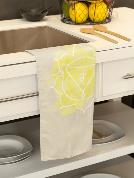 Solar Plexus Chakra hand towel featuring Manipura symbol, designed for confidence and personal power, hanging on a steel bar