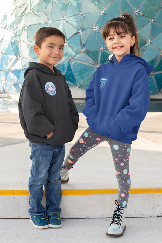 A young boy and girl wearing ocean-themed toddler hoodies with marine animal prints, perfect for cozy and stylish everyday wear.