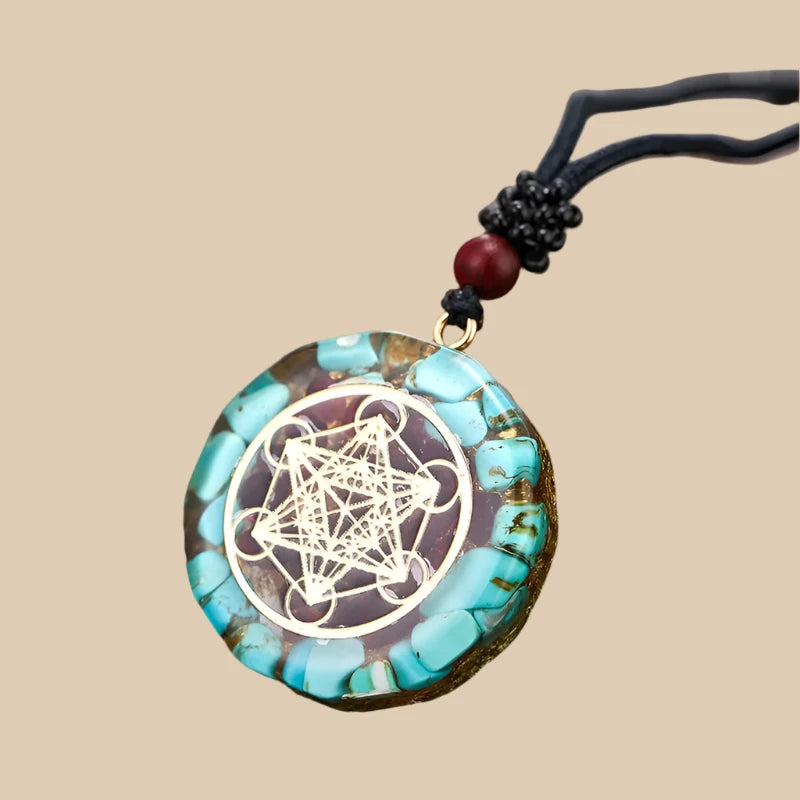  Beautiful turquoise orgonite necklace featuring the Sri Yantra symbol, promoting healing and balance.